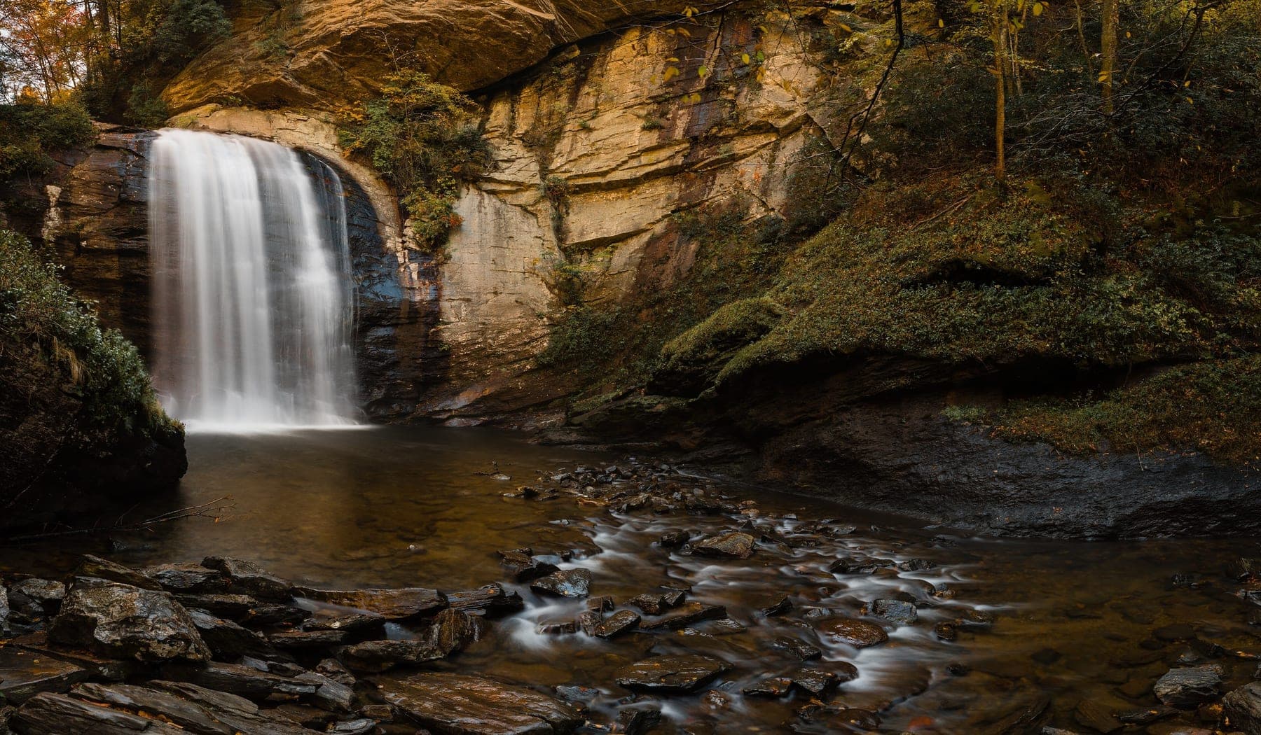 Looking Glass Falls in autumn, spilling over a rock face into a pool in the Pisgah National Forest, North Carolina